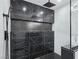 The walk-in shower has luxury black tile and a rain-style shower head at 2150 S Manzanita Dr, Pahrump, NV 89048