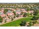 Expansive aerial view of a well-maintained community with lush green spaces and single-Gathering homes at 2509 Big Timber Dr, Las Vegas, NV 89134
