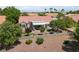 A backyard with a putting green, covered patio, mature trees and rock ground cover at 2509 Big Timber Dr, Las Vegas, NV 89134