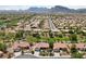 Aerial view displays a community featuring single-story homes, green spaces and mountain views at 2509 Big Timber Dr, Las Vegas, NV 89134