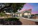 Backyard featuring a covered patio and artificial turf surrounded by rocks and mature landscaping at 2509 Big Timber Dr, Las Vegas, NV 89134