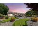 A backyard with a putting green and a covered patio in a landscaped yard with rock groundcover at 2509 Big Timber Dr, Las Vegas, NV 89134