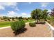 Manicured backyard featuring lush landscaping, a stone pathway, and inviting seating area, perfect for relaxation at 2509 Big Timber Dr, Las Vegas, NV 89134