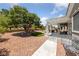 Relaxing backyard view featuring a patio cover, lush trees, and meticulous landscaping at 2509 Big Timber Dr, Las Vegas, NV 89134