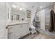Bright bathroom featuring a large mirror, modern vanity and large glass enclosed shower with horizontal tile design at 2509 Big Timber Dr, Las Vegas, NV 89134