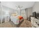 Cozy bedroom with a ceiling fan, neutral tones and a window with shutters at 2509 Big Timber Dr, Las Vegas, NV 89134