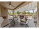 Inviting covered patio features a ceiling fan, a seating area, and an outdoor grill at 2509 Big Timber Dr, Las Vegas, NV 89134