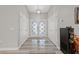 Bright foyer with modern tile flooring, white doors, and contemporary lighting fixture at 2509 Big Timber Dr, Las Vegas, NV 89134