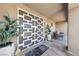 Stylish front door with modern geometric design and comfortable outdoor seating area with decorative planters at 2509 Big Timber Dr, Las Vegas, NV 89134