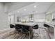 Bright kitchen features an island with seating, stainless appliances, and marble countertops at 2509 Big Timber Dr, Las Vegas, NV 89134