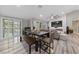 Open-concept space with a modern fireplace and dining area with large windows for natural light at 2509 Big Timber Dr, Las Vegas, NV 89134