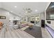 Open-concept living room with modern fireplace, hardwood floors, and view of the backyard at 2509 Big Timber Dr, Las Vegas, NV 89134