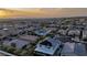 A neighborhood aerial view highlighting the community's houses and the stunning view of distant mountains during sunset at 2913 Monate Ct, Henderson, NV 89044