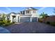 Charming two-story home with a three-car garage, brick driveway, and manicured landscaping at 2913 Monate Ct, Henderson, NV 89044