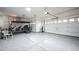 Spacious garage with epoxy floors, storage cabinets, and three garage doors plus a golf cart at 2913 Monate Ct, Henderson, NV 89044