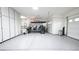 Spacious garage featuring ample storage cabinets, epoxy floors, and a dedicated space for a golf cart at 2913 Monate Ct, Henderson, NV 89044