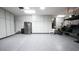 Garage boasts storage cabinets and room for a refrigerator, complemented by sleek epoxy flooring at 2913 Monate Ct, Henderson, NV 89044