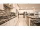 A gourmet kitchen featuring sleek countertops, white cabinetry, and stainless-steel appliances at 2913 Monate Ct, Henderson, NV 89044