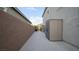 View of the exterior side yard with neutral colored siding, a block wall, and a utility shed at 2913 Monate Ct, Henderson, NV 89044