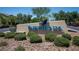 A sign displaying 'Inspirada' with a hummingbird, surrounded by lush landscaping at 2913 Monate Ct, Henderson, NV 89044