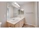 Bathroom featuring a double sink vanity and large mirror with vanity lighting at 3060 Tarpon Dr # 102, Las Vegas, NV 89120