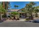 Community clubhouse featuring large glass windows, manicured landscaping, and mature trees at 3060 Tarpon Dr # 102, Las Vegas, NV 89120
