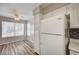 Bright dining area with wood-look floors and a large white refrigerator at 3060 Tarpon Dr # 102, Las Vegas, NV 89120