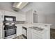 Galley kitchen featuring stainless appliances, tile backsplash, and bright white countertops at 3060 Tarpon Dr # 102, Las Vegas, NV 89120