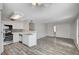 Spacious living area with white kitchen, stainless steel appliances, and wood flooring at 3060 Tarpon Dr # 102, Las Vegas, NV 89120