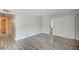 Spacious living room with wood-look flooring, great natural light, and neutral walls at 3060 Tarpon Dr # 102, Las Vegas, NV 89120