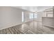 Bright living room with wood-look floors, ceiling fan, and view from windows at 3060 Tarpon Dr # 102, Las Vegas, NV 89120