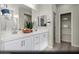 Bright primary bathroom with double vanity, white cabinets, and walk-in shower at 314 S Parawan St # Lot 13, Henderson, NV 89015