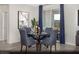 Dining room features a glass table, tufted chairs, and elegant decor at 314 S Parawan St # Lot 13, Henderson, NV 89015