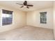 Bedroom featuring carpeted floors, windows, and ceiling fan at 3189 Pinehurst Dr # B, Las Vegas, NV 89109