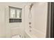 Neat bathroom with a tub, shower, and toilet, complemented by a wall-mounted cabinet for storage at 3194 Lumassina Way, Henderson, NV 89044