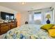 Bright bedroom featuring a patterned quilt, soft natural light, and neutral walls at 3194 Lumassina Way, Henderson, NV 89044