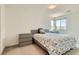 Cozy bedroom with neutral tones, a queen-sized bed, a nightstand, and natural light from the window at 3194 Lumassina Way, Henderson, NV 89044
