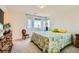 Bright bedroom featuring a patterned quilt, soft natural light, and neutral walls at 3194 Lumassina Way, Henderson, NV 89044