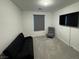 This is a simple bedroom featuring light gray carpet, a small chair, and a futon at 3194 Lumassina Way, Henderson, NV 89044
