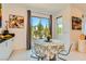 Dining area with a round table, stylish chairs, and view of the outdoor patio space at 3194 Lumassina Way, Henderson, NV 89044