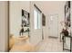 Bright entryway with modern artwork, decorative vases, and tile flooring at 3194 Lumassina Way, Henderson, NV 89044