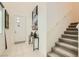 Inviting foyer with neutral tile flooring, stairway, and stylish decorations at 3194 Lumassina Way, Henderson, NV 89044