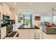 Open-concept kitchen with a large island, stainless steel appliances, and seamless flow to the living area at 3194 Lumassina Way, Henderson, NV 89044