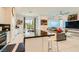 Stylish kitchen island with seating, stainless appliances, and an open-concept layout to the living area at 3194 Lumassina Way, Henderson, NV 89044