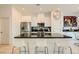 Bright kitchen showcasing a large island with seating, modern appliances, and a decorative backsplash at 3194 Lumassina Way, Henderson, NV 89044