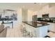 Modern kitchen with stainless steel appliances, counter seating, and an open floorplan to the home at 3194 Lumassina Way, Henderson, NV 89044