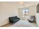 Living room with comfortable gray seating, a mounted TV, and a view from the window, perfect for relaxing at 3194 Lumassina Way, Henderson, NV 89044