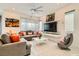 Bright, open living room with stylish decor, modern TV, and comfortable seating arrangements at 3194 Lumassina Way, Henderson, NV 89044