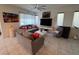 Bright living room with neutral tones, tile flooring, and modern furniture at 3194 Lumassina Way, Henderson, NV 89044