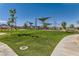 Expansive community park with lush green grass, walking paths, and mature trees at 3194 Lumassina Way, Henderson, NV 89044
